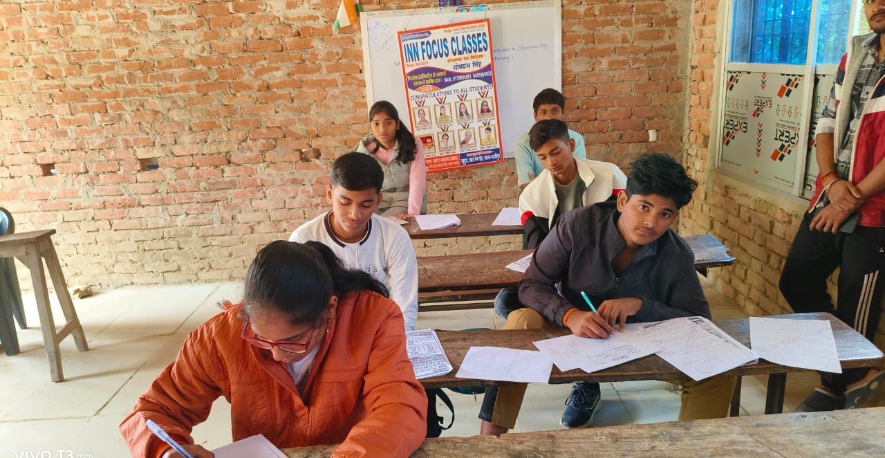 Students writing during class at INN Focus